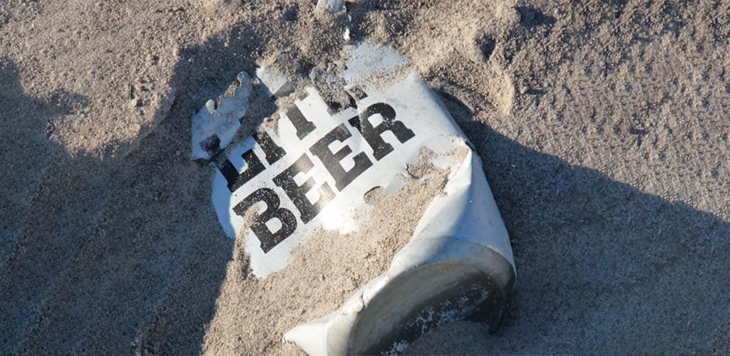 image of lite beer can on sand beach